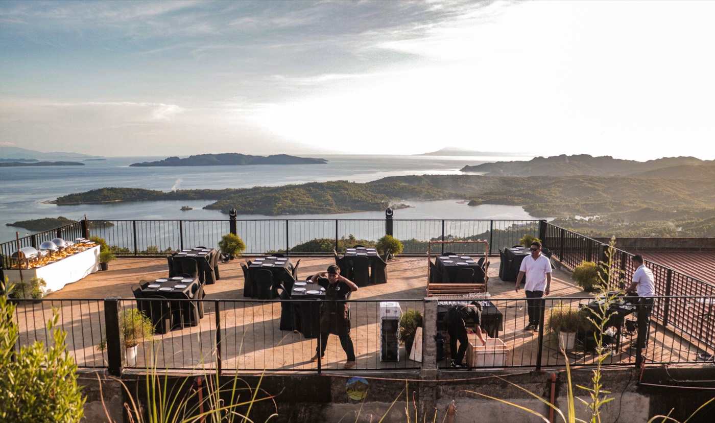 The rebuilt open-air terrace at Laaganan, tables set along the railing above the islands